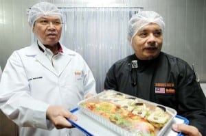 Ibrahim (left) and assistant executive chef Zainuddin Md Isa showing off some of Brahim’s food products during a tour of the company’s facilities. S.S.KANESAN/THE STAR