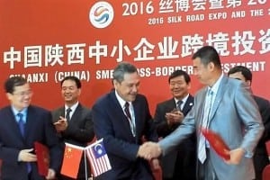 Working together: Hamidon receving a halal certification proposal during the Shaanxi business-matching event.
