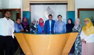 Dr Nur Rahman (4th R), CEO of Ghanim International Corporation, poses for a group photo with Brunei Halal staff members at their new head office in Gadong.